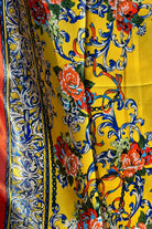 Yellow satin scarf with blue baroque scrolls and red floral print draped in sunlight - boho satin scarves Australia.