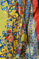 Yellow satin scarf with blue baroque scrolls and red floral print draped in sunlight - boho satin scarves Australia.