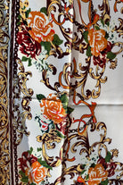 Brown satin square scarf with baroque floral print and red border in vintage-inspired warm tones.