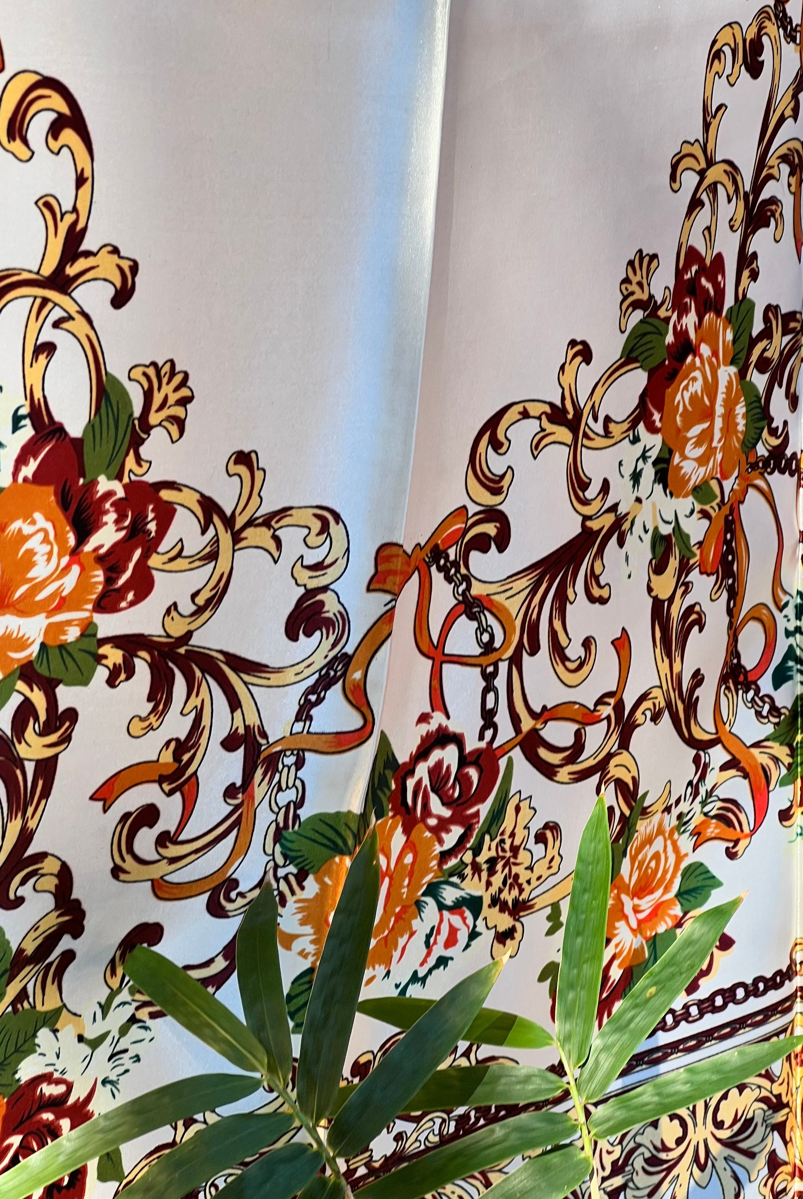 Brown satin square scarf with baroque floral print and red border in vintage-inspired warm tones.