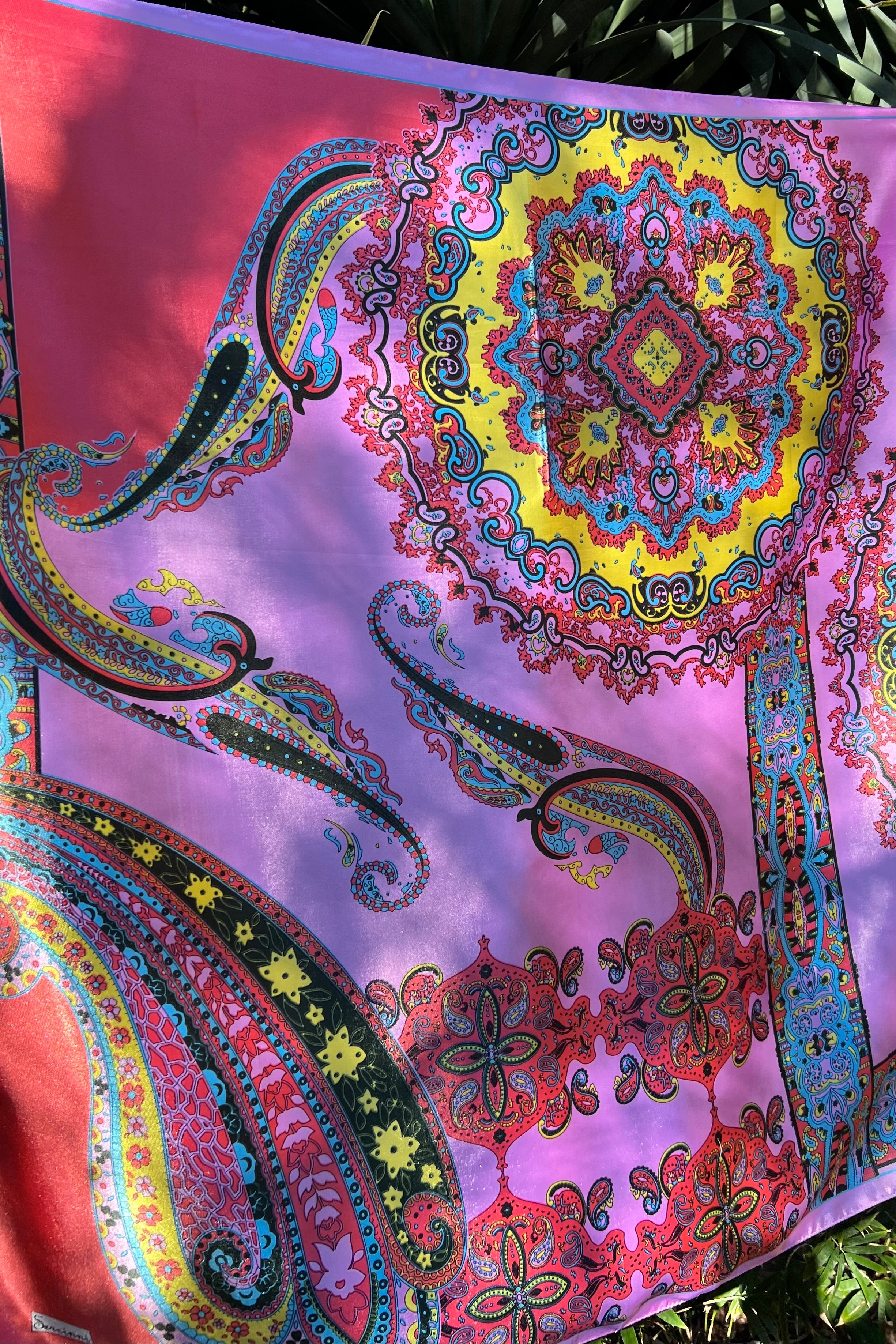 Bright silk satin scarf with paisley and mandala print in lilac, yellow, coral and teal. 90x90cm. Polyester with luxe sheen.