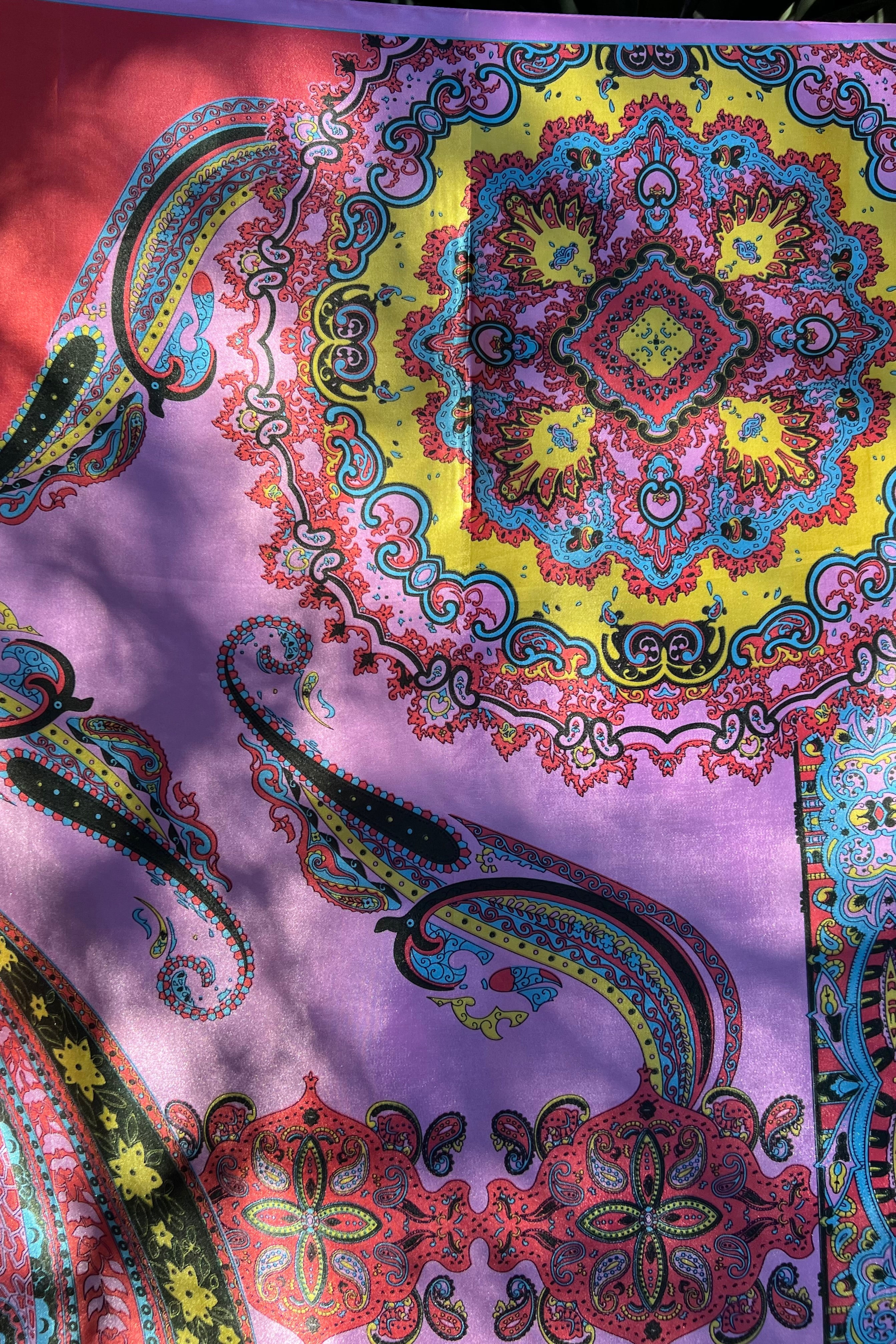 Bright silk satin scarf with paisley and mandala print in lilac, yellow, coral and teal. 90x90cm. Polyester with luxe sheen.