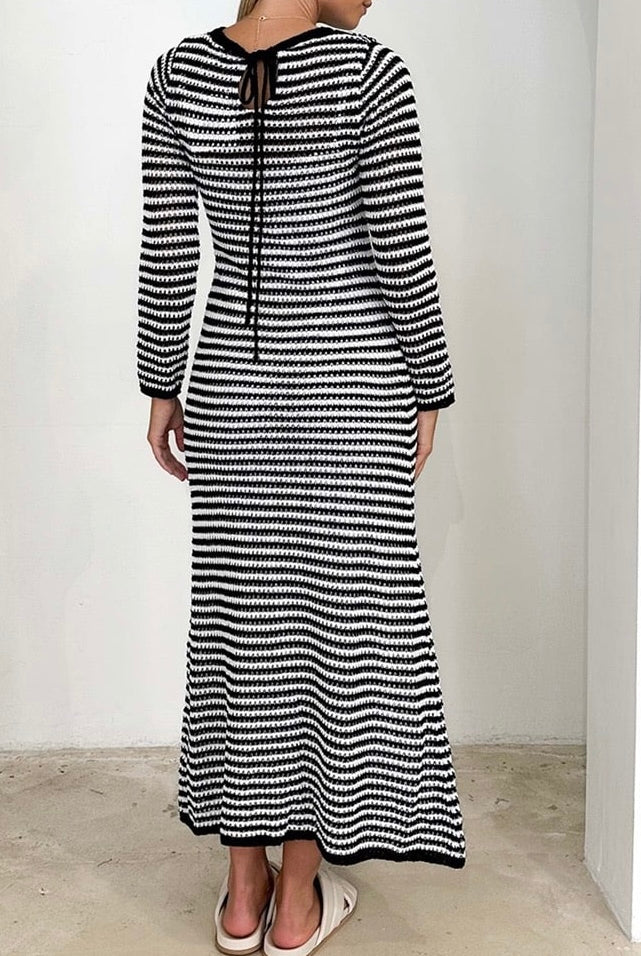 Woman wearing black and white striped knit maxi dress with long sleeves and round neckline - boho cotton knit dress Australia.