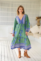 Model wearing Bluebird Willa Boho Midi Dress by Jaase - floral print, long sleeves, 100% rayon, relaxed fit.