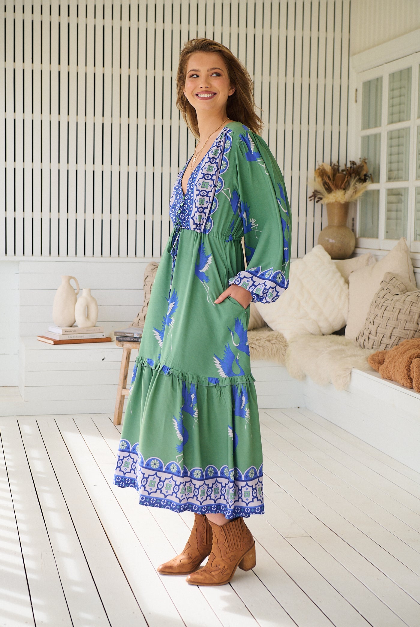 Model wearing Bluebird Willa Boho Midi Dress by Jaase - floral print, long sleeves, 100% rayon, drawstring waist.