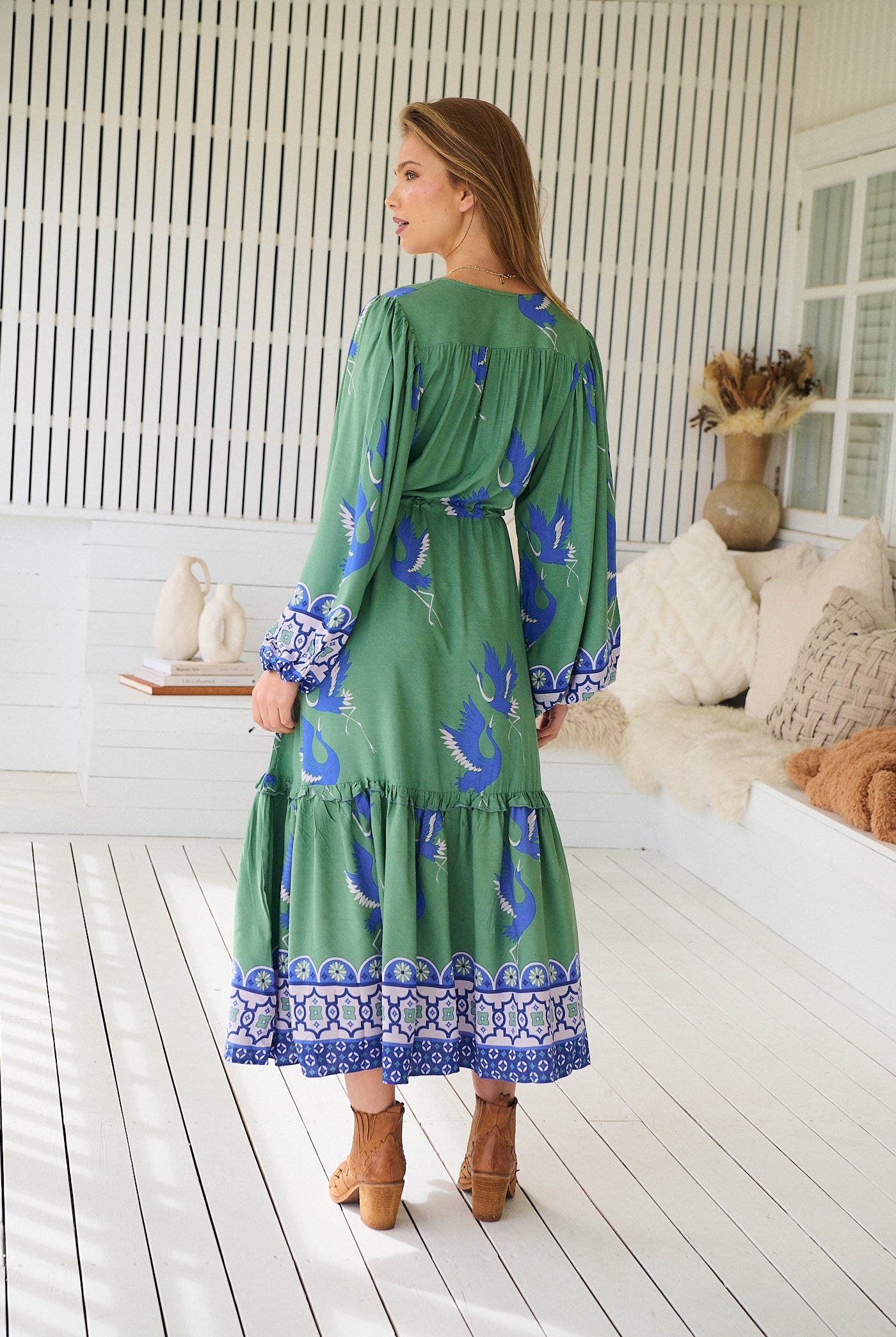Model wearing Bluebird Willa Boho Midi Dress by Jaase - floral print, long sleeves, 100% rayon, drawstring waist.