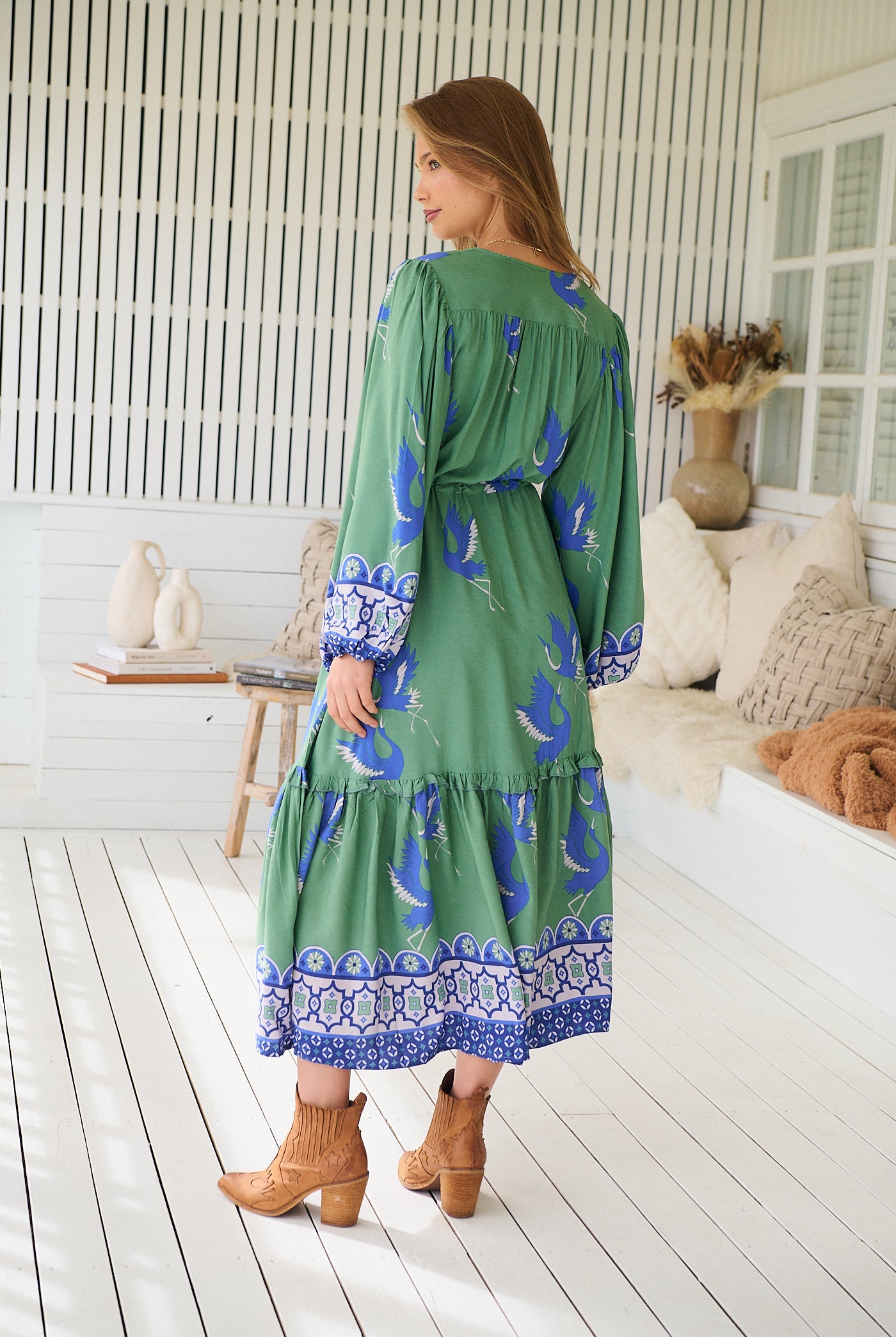 Model wearing Bluebird Willa Boho Midi Dress by Jaase - floral print, long sleeves, 100% rayon, drawstring waist.