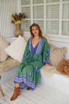 Model wearing Bluebird Willa Boho Midi Dress by Jaase - floral print, long sleeves, 100% rayon, relaxed fit.