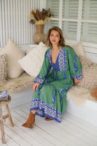 Model wearing Bluebird Willa Boho Midi Dress by Jaase - floral print, long sleeves, 100% rayon, relaxed fit.