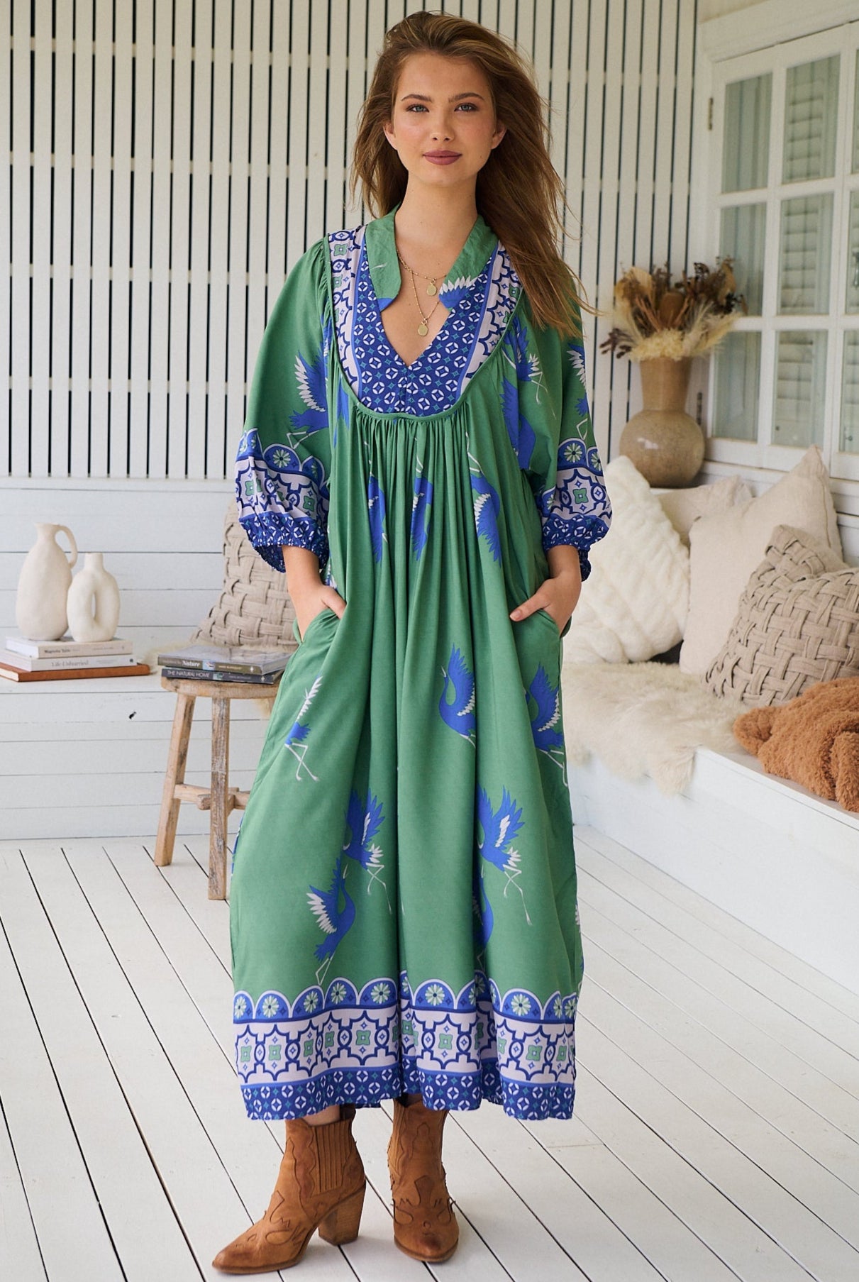 Model wearing Bluebird Boheme Midi Dress by Jaase - boho floral print, long sleeves, soft rayon fabric, relaxed flowy silhouette.