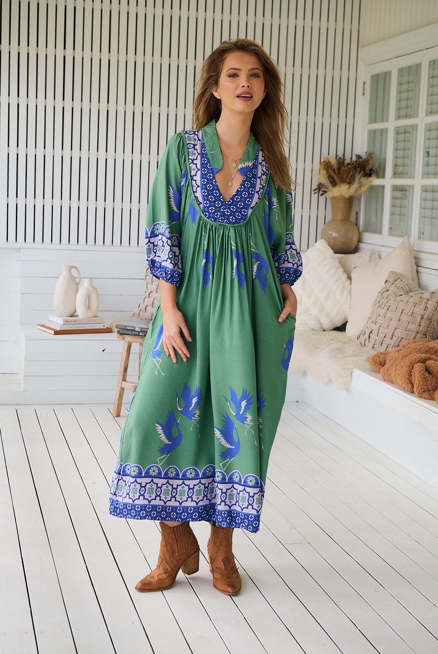 Model wearing Bluebird Boheme Midi Dress by Jaase - boho floral print, long sleeves, soft rayon fabric, relaxed flowy silhouette.