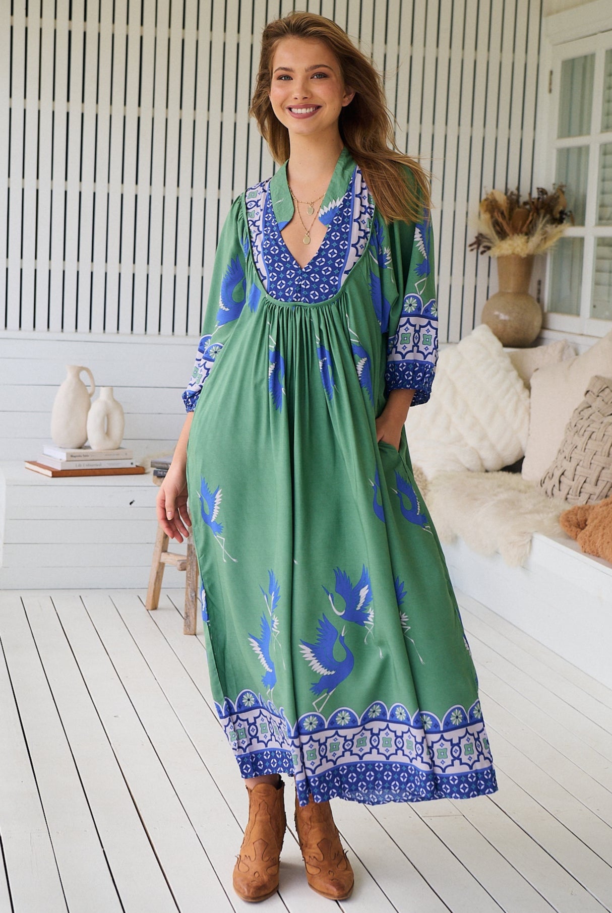 Model wearing Bluebird Boheme Midi Dress by Jaase - boho floral print, long sleeves, soft rayon fabric, relaxed flowy silhouette.