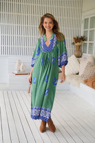 Model wearing Bluebird Boheme Midi Dress by Jaase - boho floral print, long sleeves, soft rayon fabric, relaxed flowy silhouette.