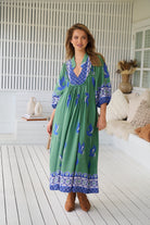 Model wearing Bluebird Boheme Midi Dress by Jaase - boho floral print, long sleeves, soft rayon fabric, relaxed flowy silhouette.