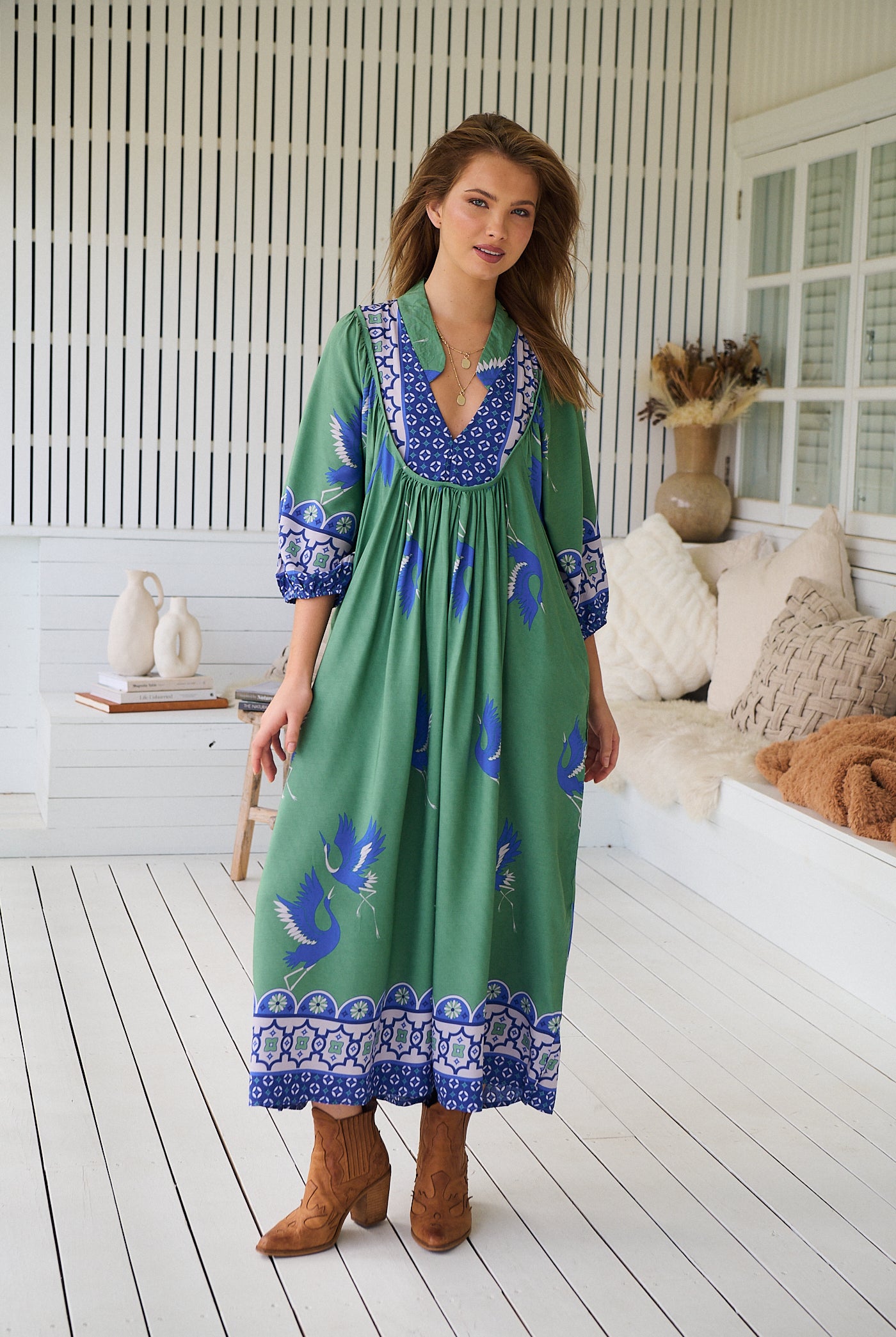 Model wearing Bluebird Boheme Midi Dress by Jaase - boho floral print, long sleeves, soft rayon fabric, relaxed flowy silhouette.