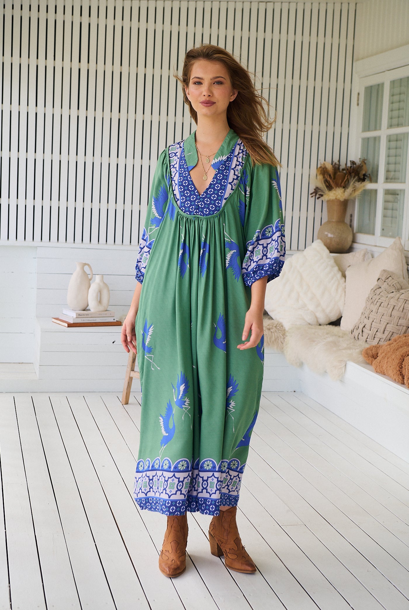 Model wearing Bluebird Boheme Midi Dress by Jaase - boho floral print, long sleeves, soft rayon fabric, relaxed flowy silhouette.
