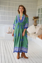 Model wearing Bluebird Boheme Midi Dress by Jaase - boho floral print, long sleeves, soft rayon fabric, relaxed flowy silhouette.