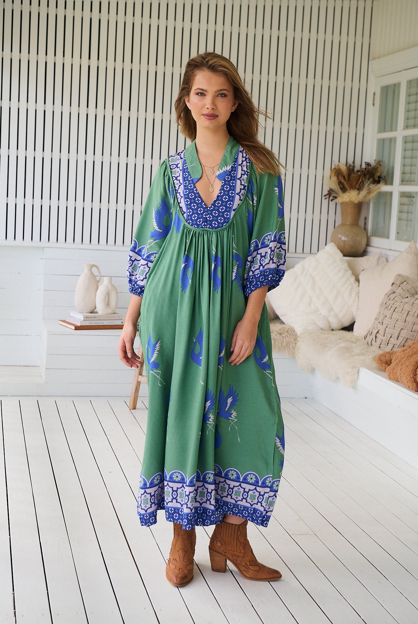 Model wearing Bluebird Boheme Midi Dress by Jaase - boho floral print, long sleeves, soft rayon fabric, relaxed flowy silhouette.
