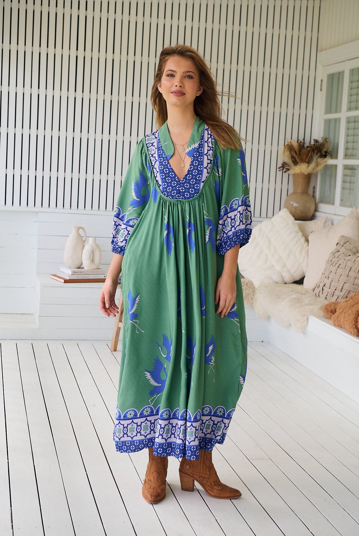 Model wearing Bluebird Boheme Midi Dress by Jaase - boho floral print, long sleeves, soft rayon fabric, relaxed flowy silhouette.