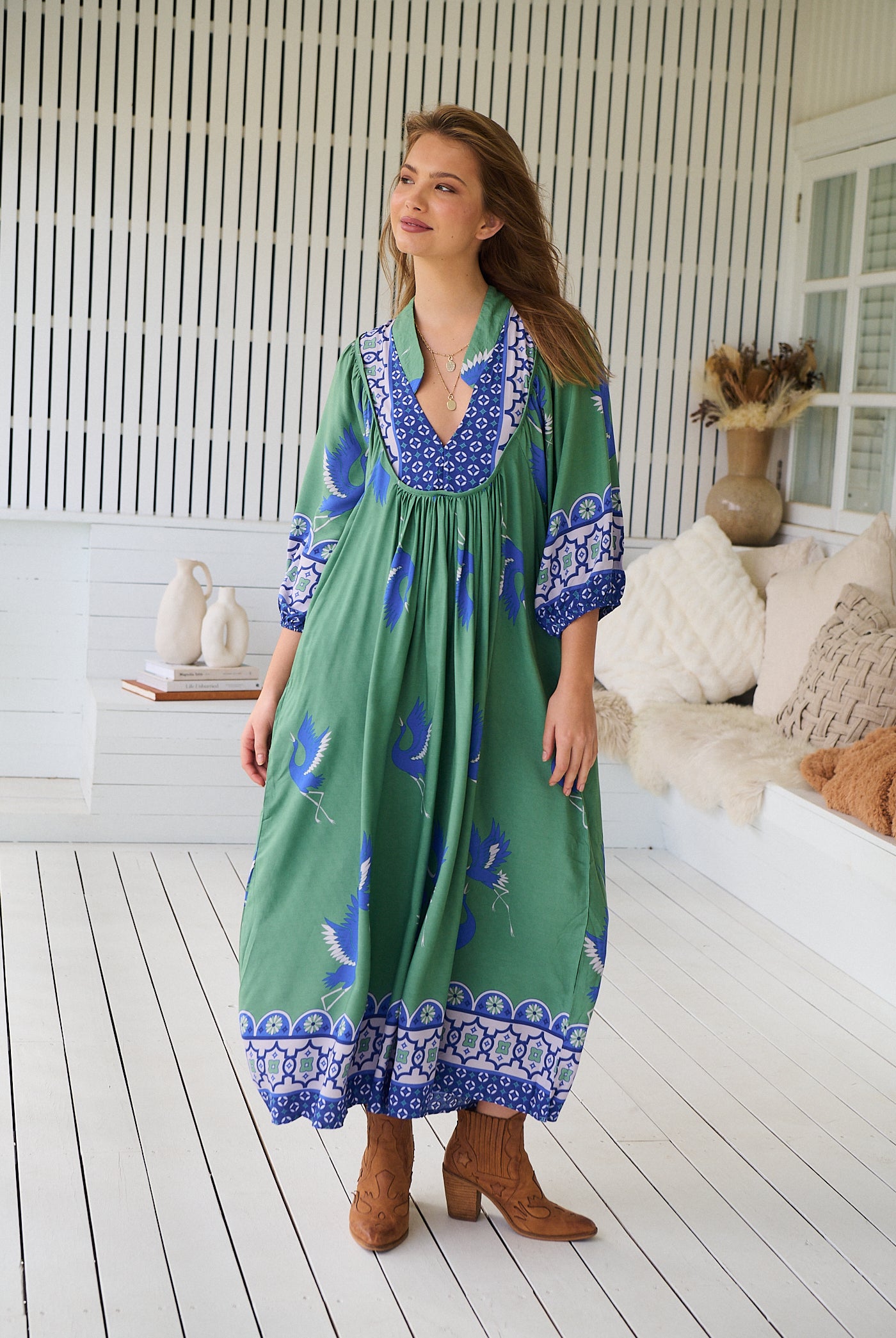 Model wearing Bluebird Boheme Midi Dress by Jaase - boho floral print, long sleeves, soft rayon fabric, relaxed flowy silhouette.