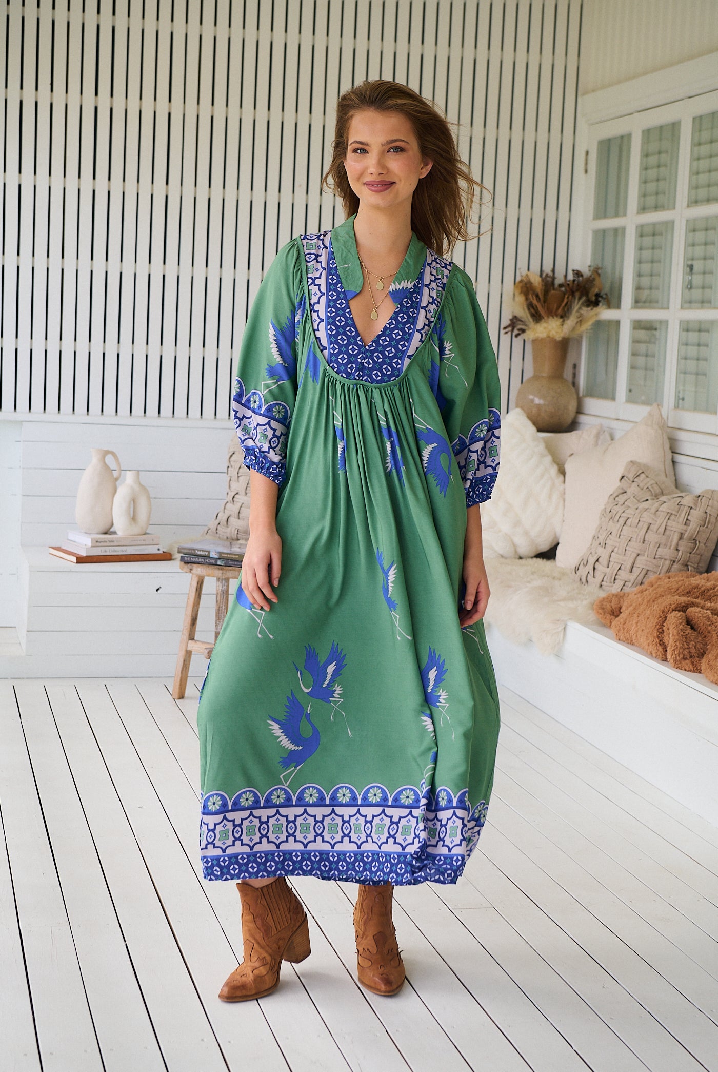 Model wearing Bluebird Boheme Midi Dress by Jaase - boho floral print, long sleeves, soft rayon fabric, relaxed flowy silhouette.