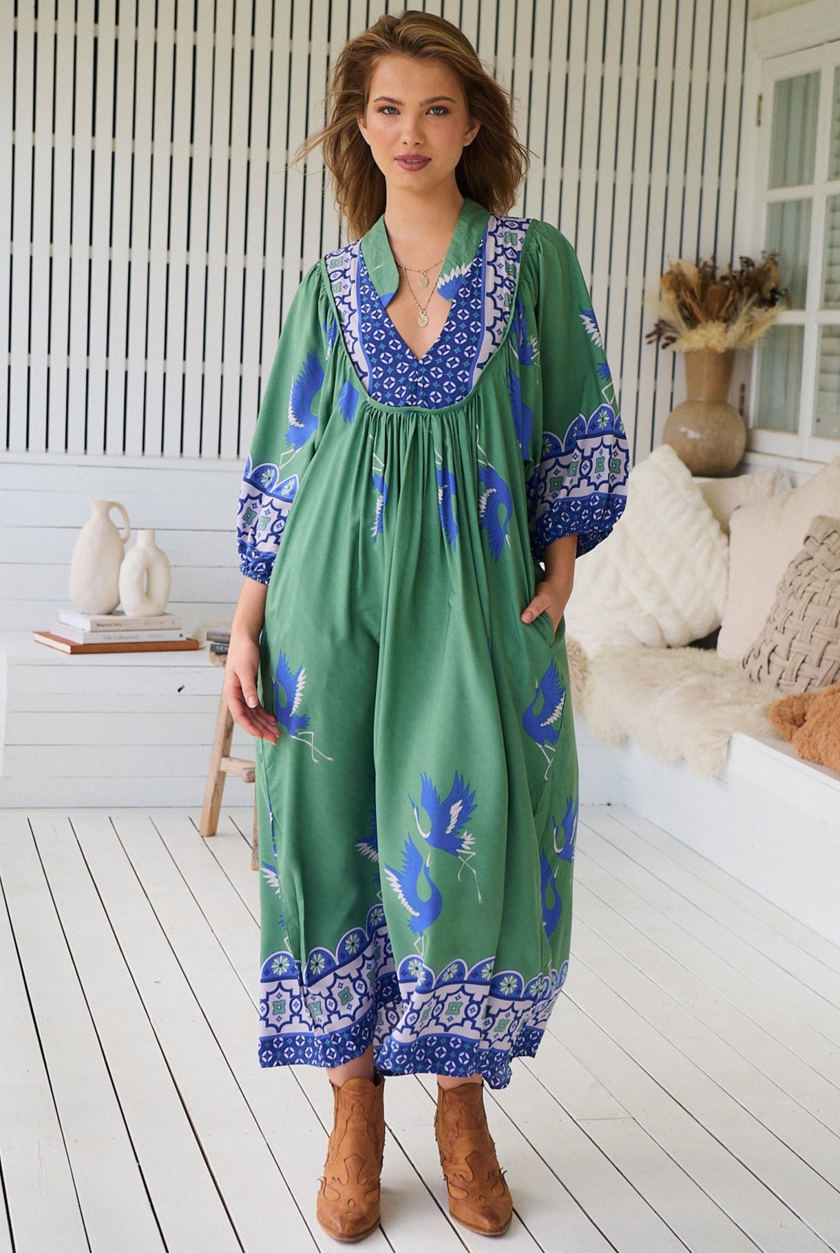 Model wearing Bluebird Boheme Midi Dress by Jaase - boho floral print, long sleeves, soft rayon fabric, relaxed flowy silhouette.
