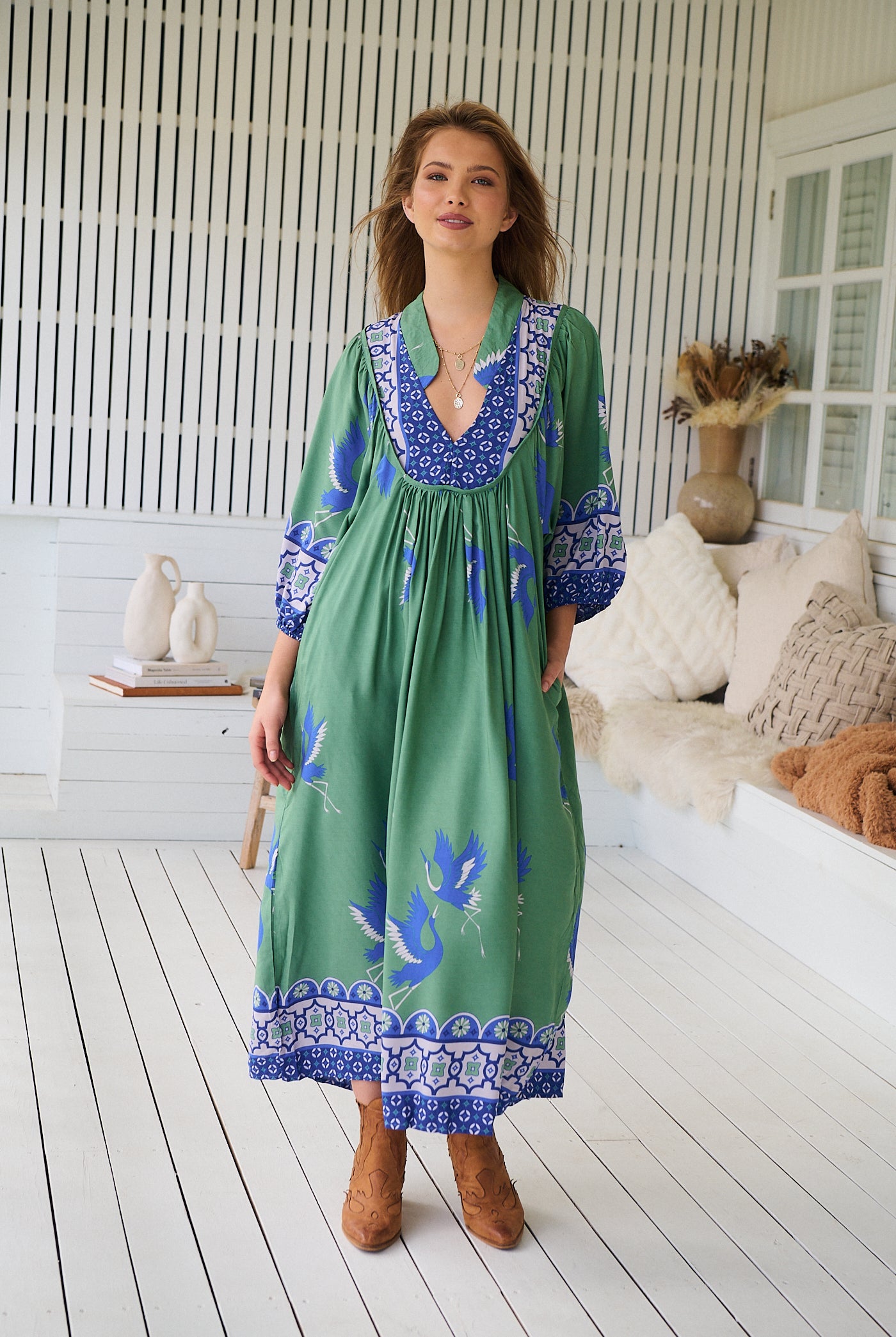 Model wearing Bluebird Boheme Midi Dress by Jaase - boho floral print, long sleeves, soft rayon fabric, relaxed flowy silhouette.