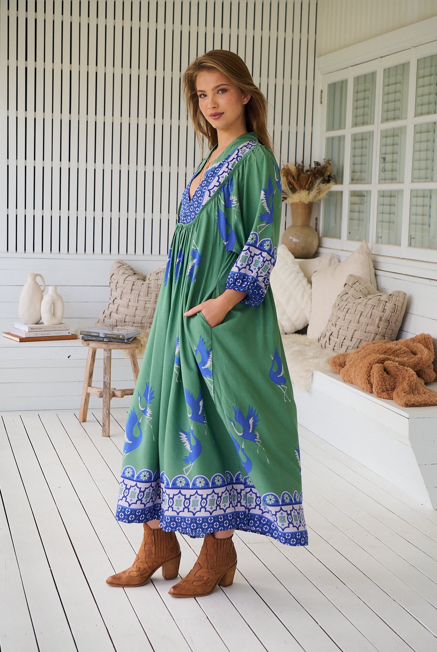 Model wearing Bluebird Boheme Midi Dress by Jaase - boho floral print, long sleeves, soft rayon fabric, relaxed flowy silhouette.