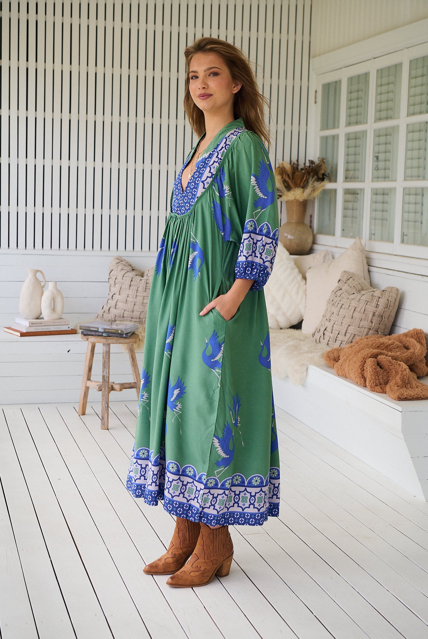 Model wearing Bluebird Boheme Midi Dress by Jaase - boho floral print, long sleeves, soft rayon fabric, relaxed flowy silhouette.