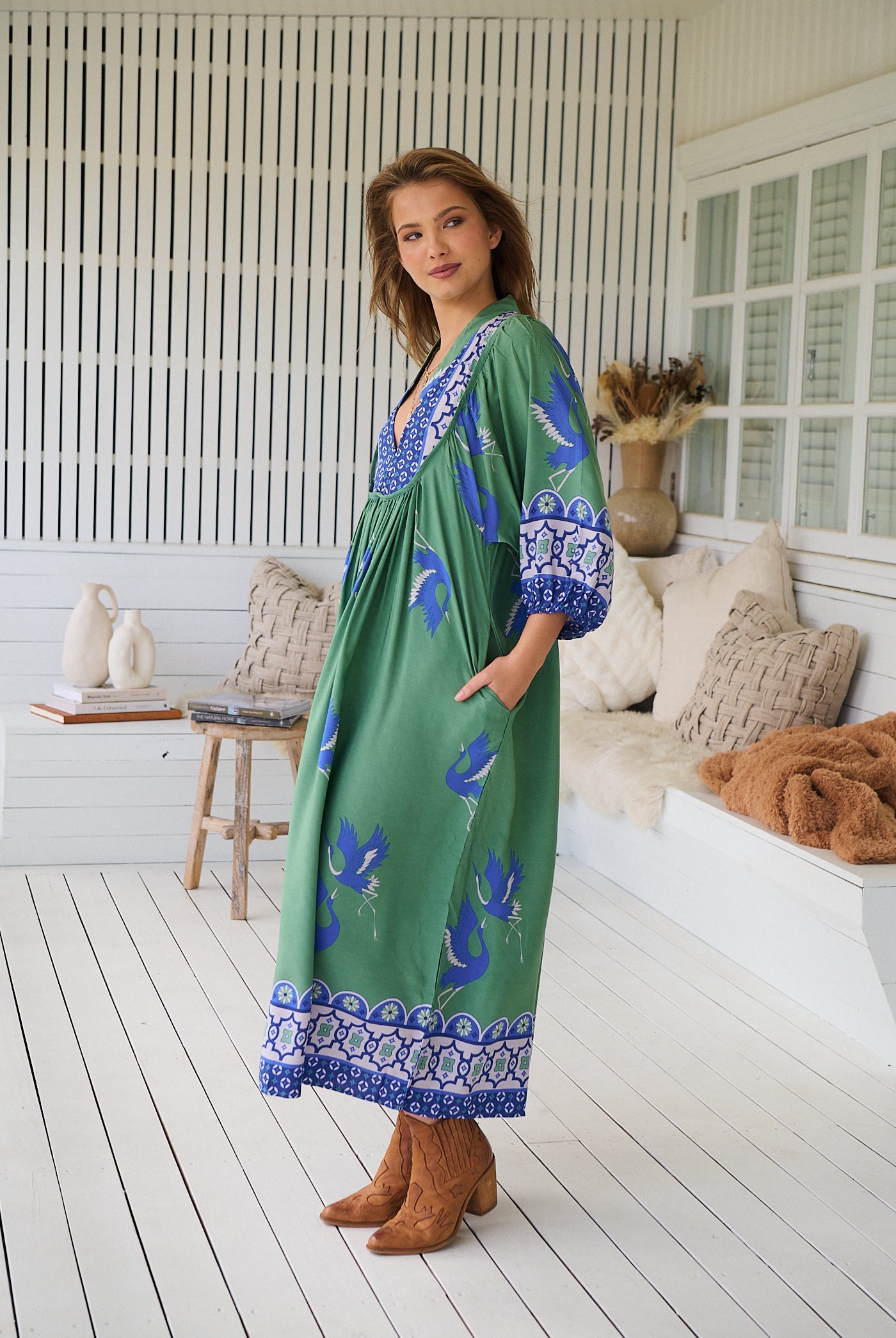 Model wearing Bluebird Boheme Midi Dress by Jaase - boho floral print, long sleeves, soft rayon fabric, relaxed flowy silhouette.