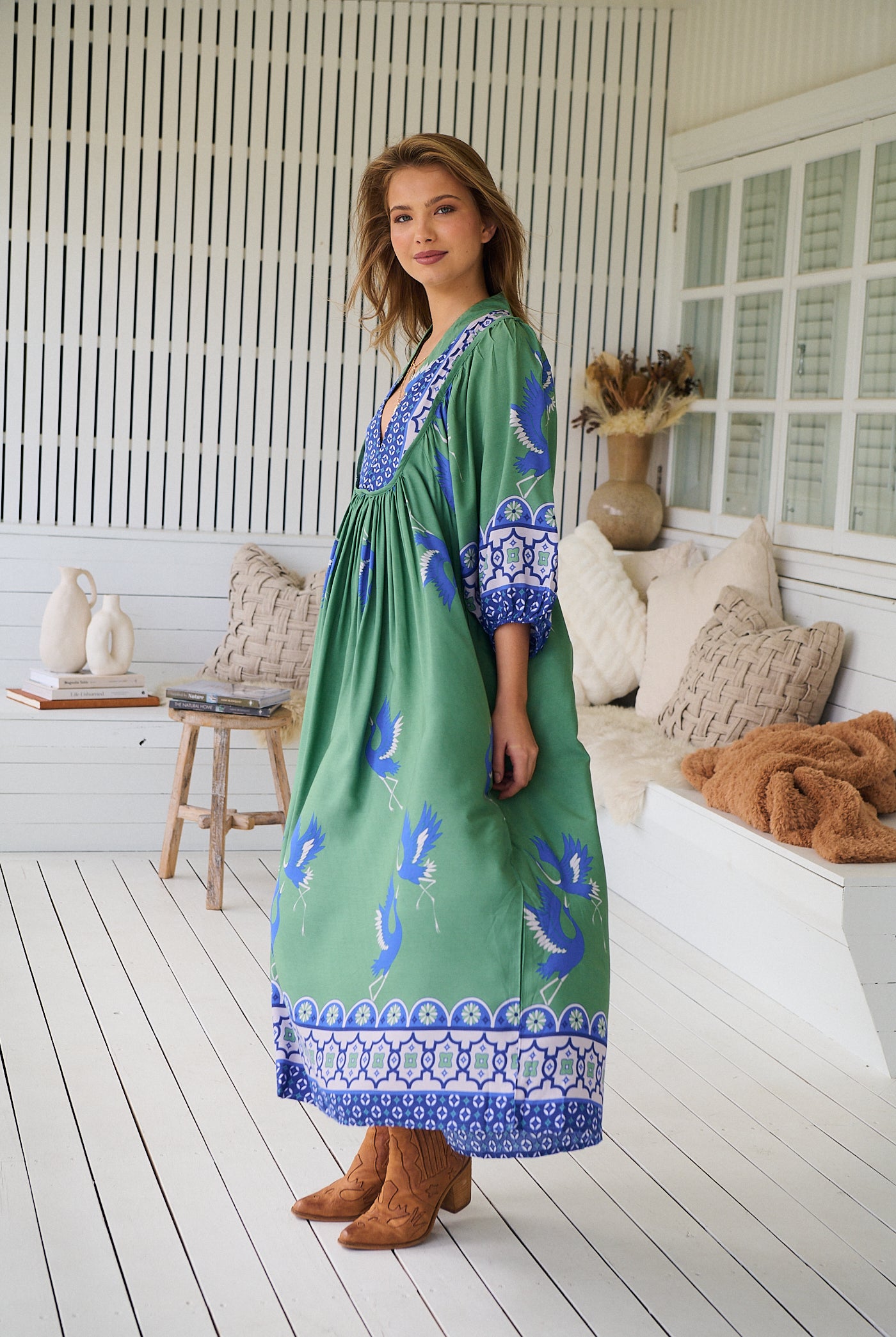 Model wearing Bluebird Boheme Midi Dress by Jaase - boho floral print, long sleeves, soft rayon fabric, relaxed flowy silhouette.