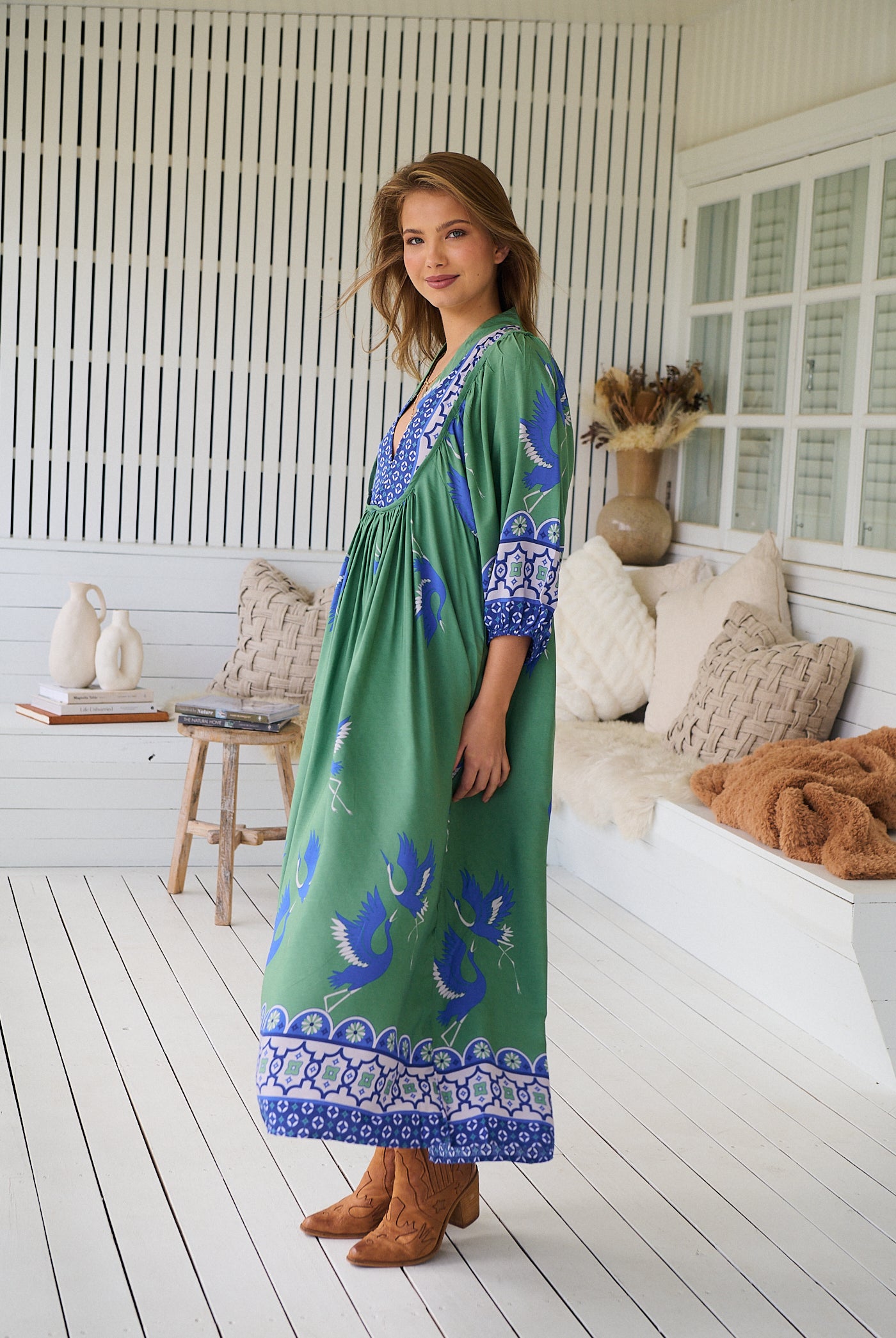 Model wearing Bluebird Boheme Midi Dress by Jaase - boho floral print, long sleeves, soft rayon fabric, relaxed flowy silhouette.