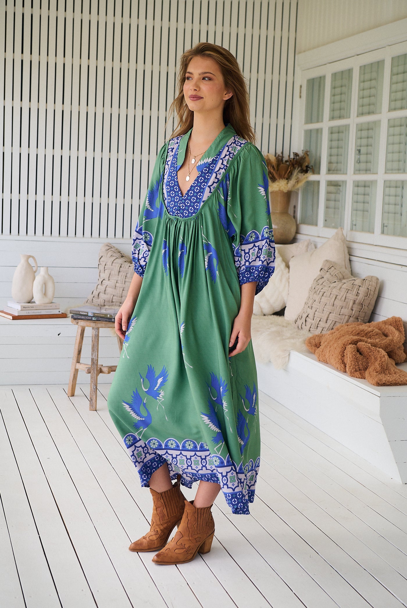 Model wearing Bluebird Boheme Midi Dress by Jaase - boho floral print, long sleeves, soft rayon fabric, relaxed flowy silhouette.