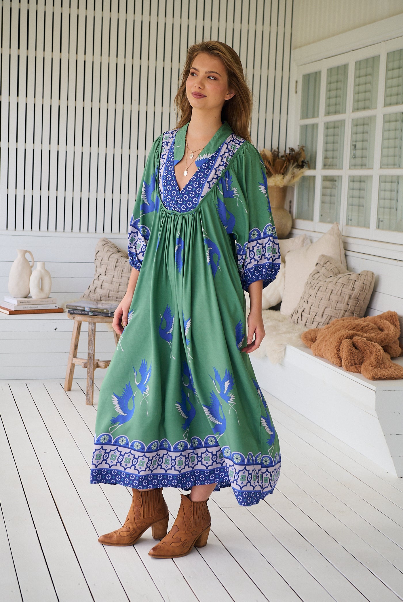 Model wearing Bluebird Boheme Midi Dress by Jaase - boho floral print, long sleeves, soft rayon fabric, relaxed flowy silhouette.