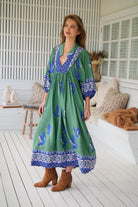 Model wearing Bluebird Boheme Midi Dress by Jaase - boho floral print, long sleeves, soft rayon fabric, relaxed flowy silhouette.