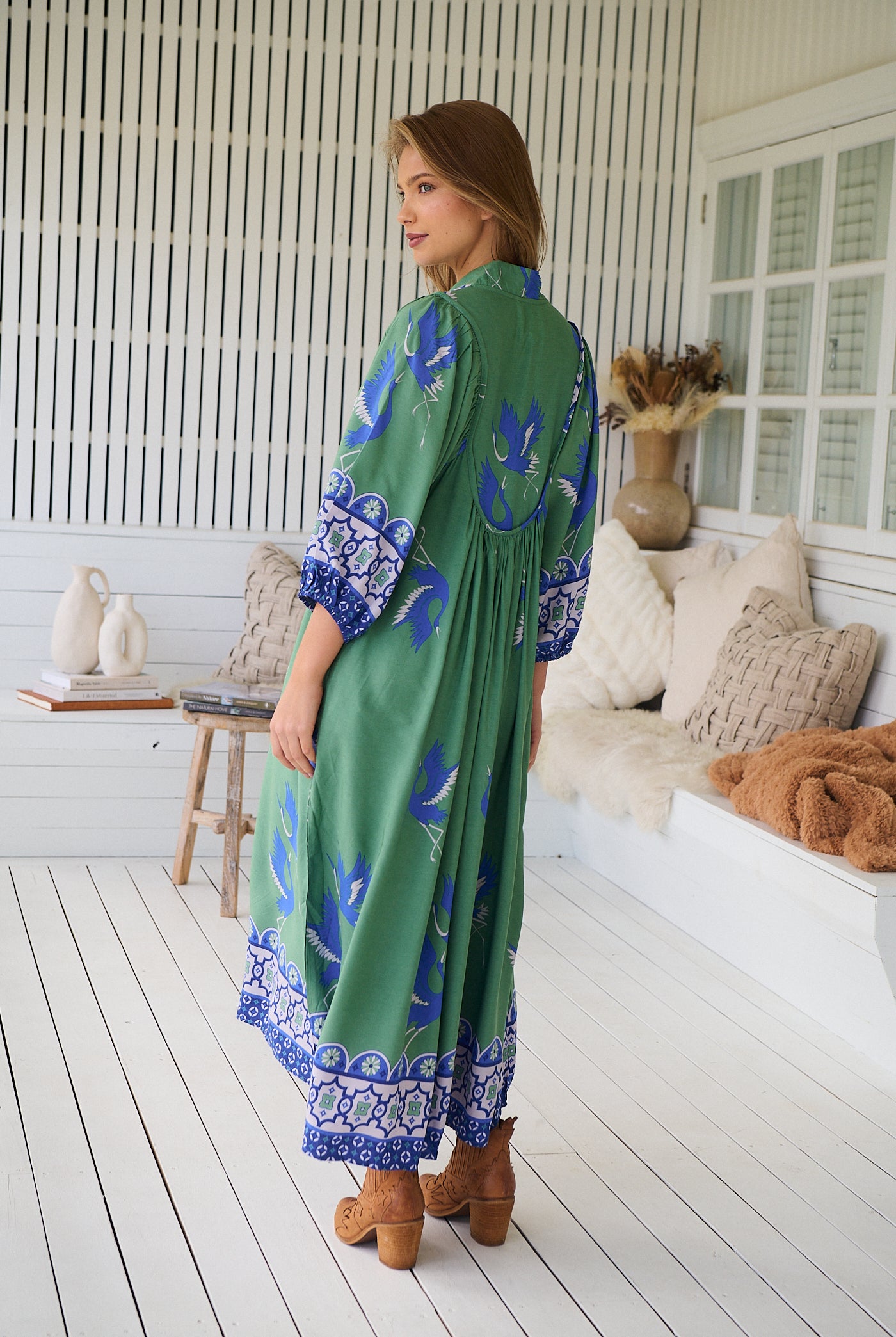 Model wearing Bluebird Boheme Midi Dress by Jaase - boho floral print, long sleeves, soft rayon fabric, relaxed flowy silhouette.