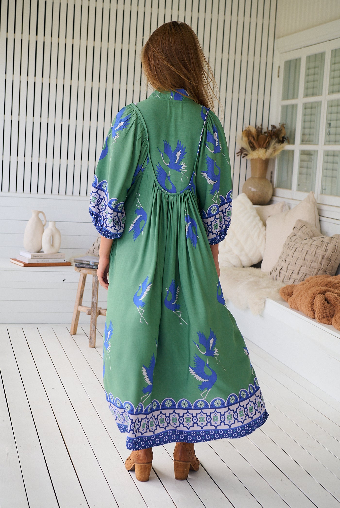 Model wearing Bluebird Boheme Midi Dress by Jaase - boho floral print, long sleeves, soft rayon fabric, relaxed flowy silhouette.