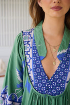 Model wearing Bluebird Boheme Midi Dress by Jaase - boho floral print, long sleeves, soft rayon fabric, relaxed flowy silhouette.