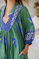 Model wearing Bluebird Boheme Midi Dress by Jaase - boho floral print, long sleeves, soft rayon fabric, relaxed flowy silhouette.