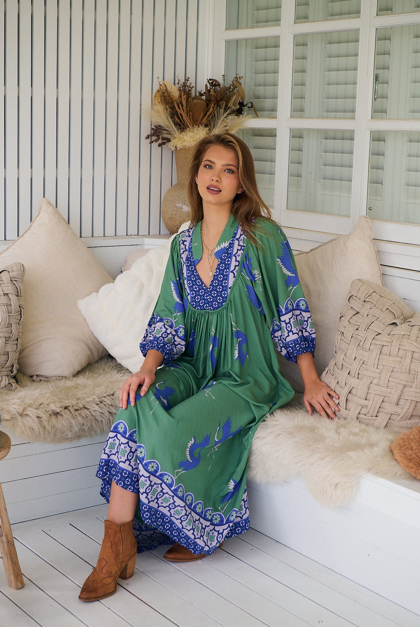 Model wearing Bluebird Boheme Midi Dress by Jaase - boho floral print, long sleeves, soft rayon fabric, relaxed flowy silhouette.