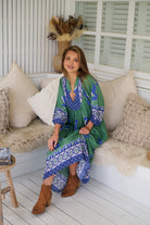 Model wearing Bluebird Boheme Midi Dress by Jaase - boho floral print, long sleeves, soft rayon fabric, relaxed flowy silhouette.