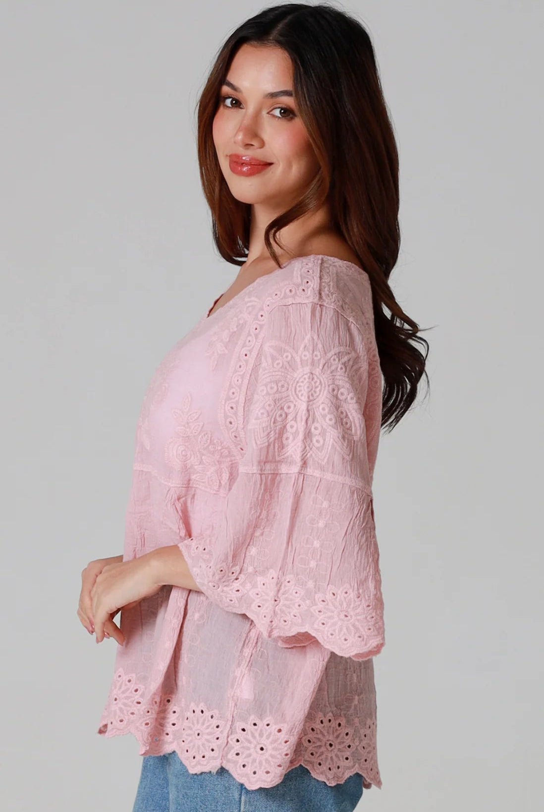 Woman wearing pink embroidered cotton boho blouse with scalloped hem - Marabel Boho Tops Australia.