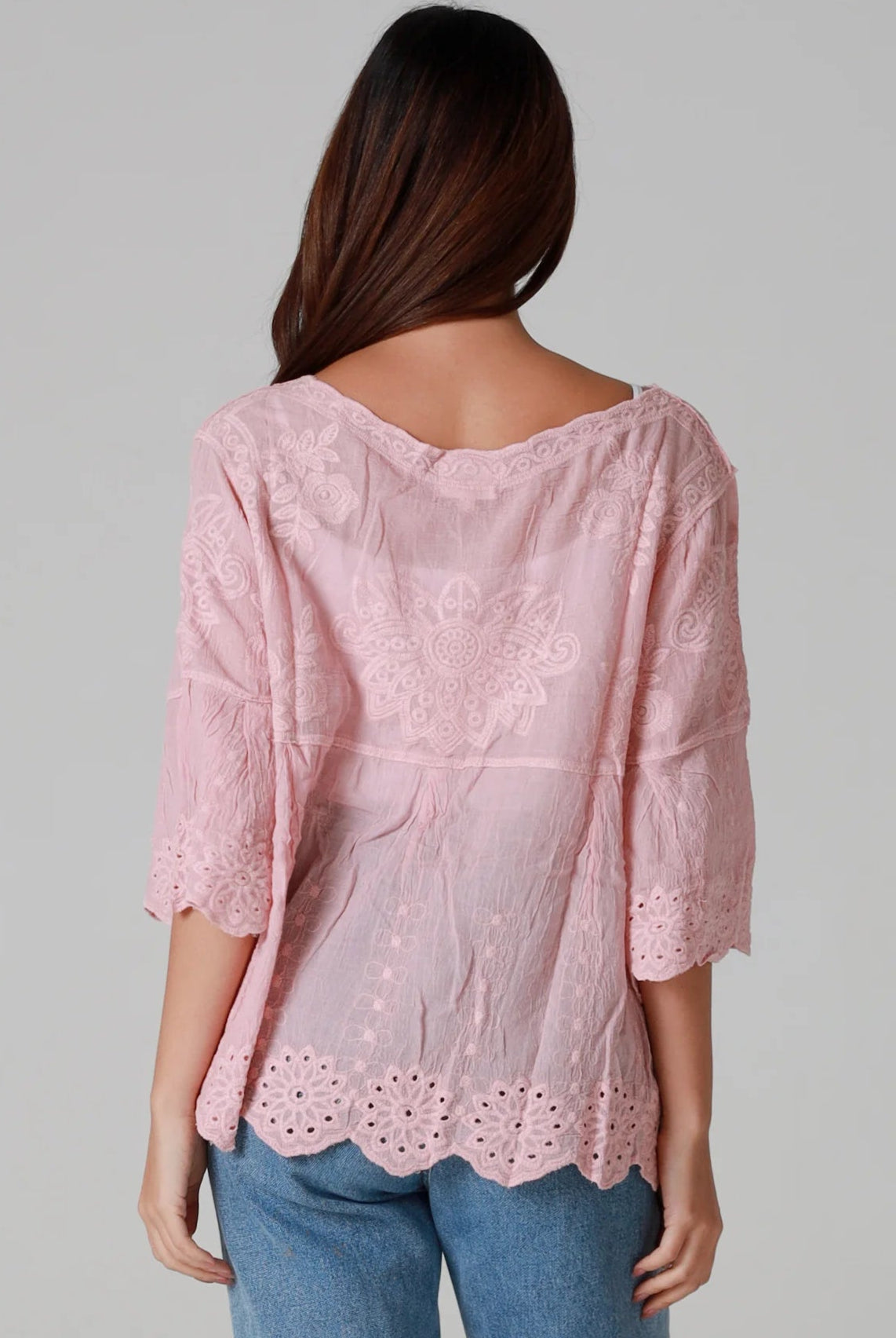 Woman wearing pink embroidered cotton boho blouse with scalloped hem - Marabel Boho Tops Australia.