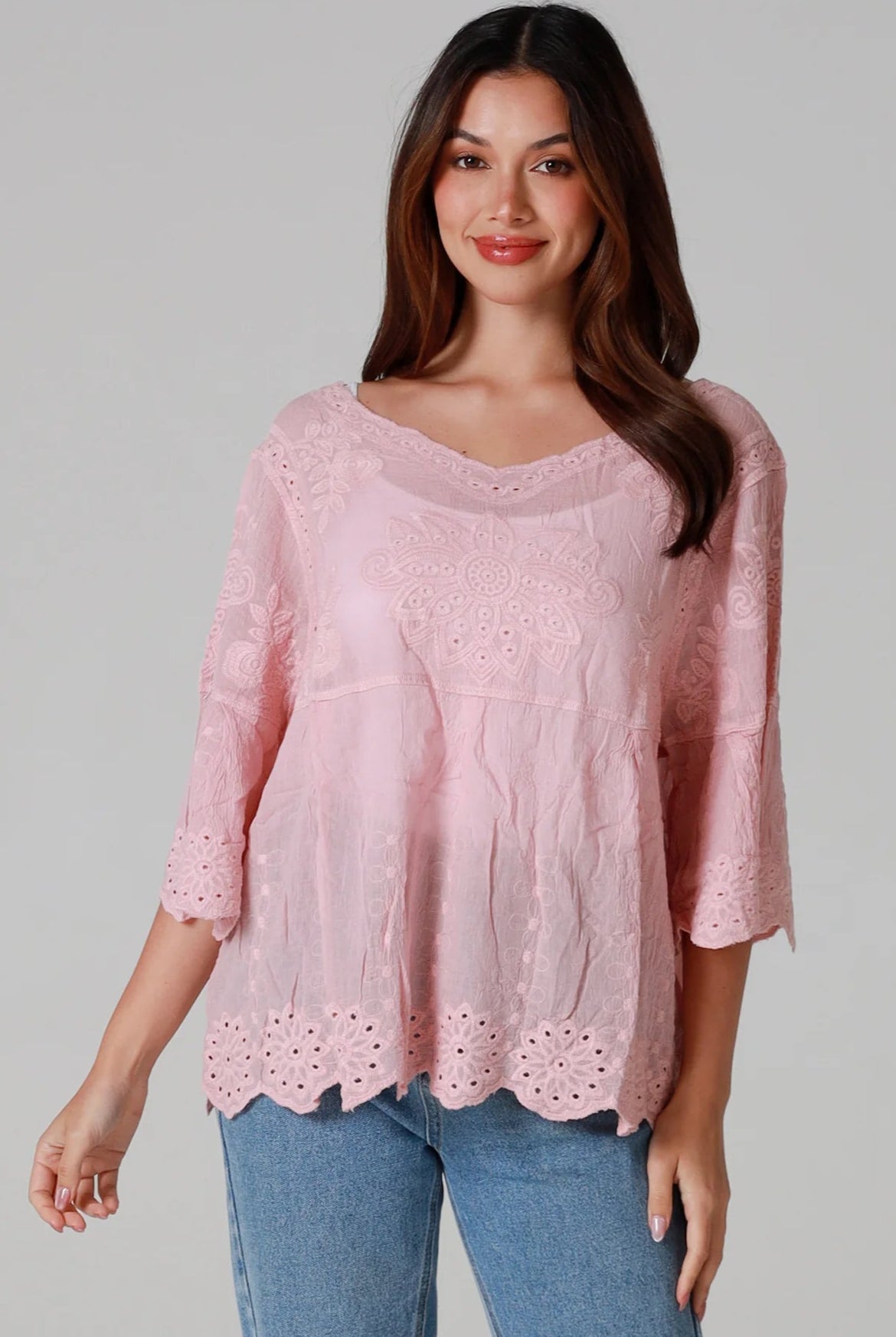 Woman wearing pink embroidered cotton boho blouse with scalloped hem - Marabel Boho Tops Australia.