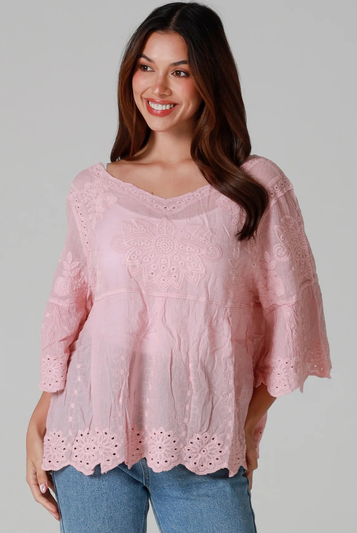 Woman wearing pink embroidered cotton boho blouse with scalloped hem - Marabel Boho Tops Australia.