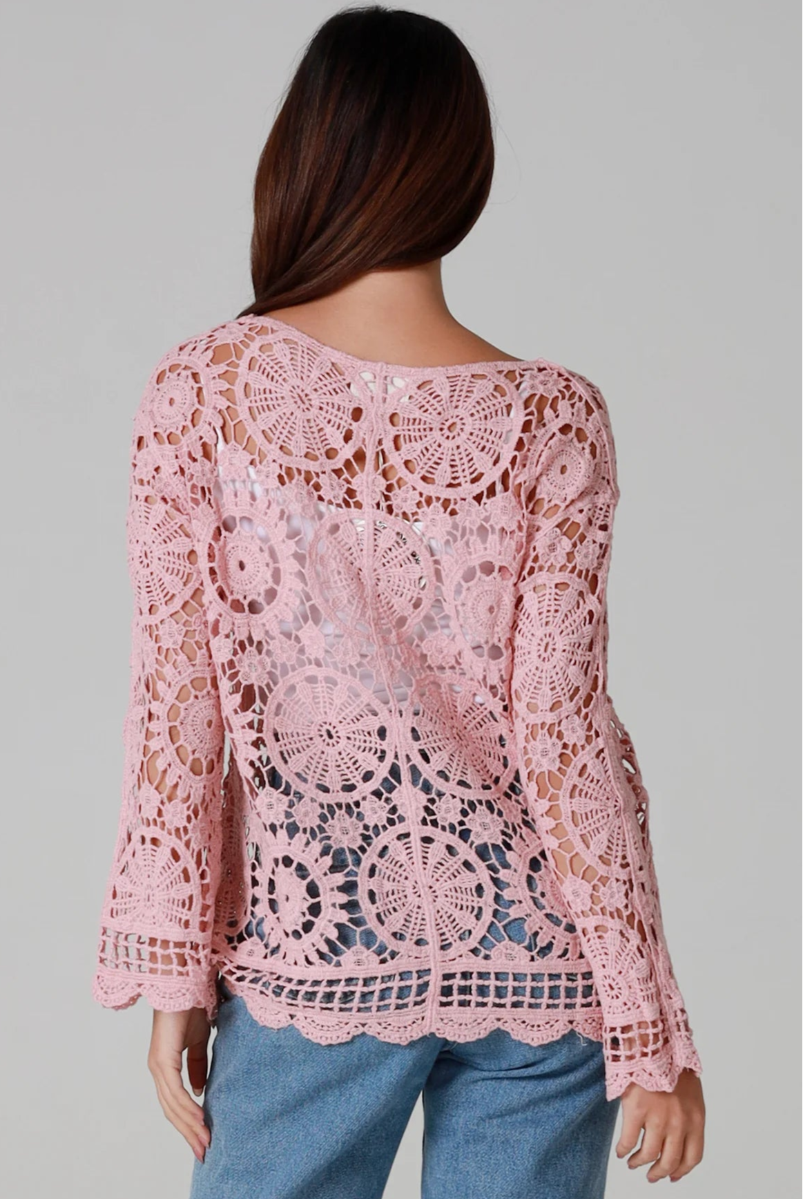 Women in blush pink cotton crochet cardigan with tie front and scalloped hem - boho chic cardigan Australia.