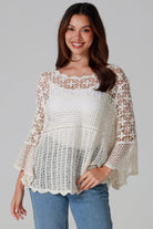 Woman wearing cream cotton crochet top with scalloped neckline and bell sleeves - Boho crochet blouse Australia.