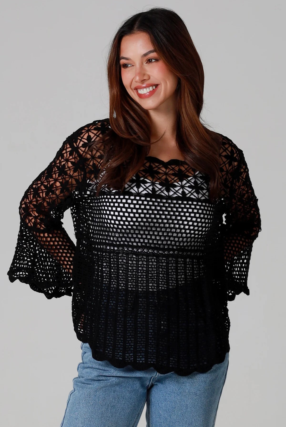 woman wearing black cotton crochet top with scalloped sleeves and flared hem - Boho crochet blouse Australia.