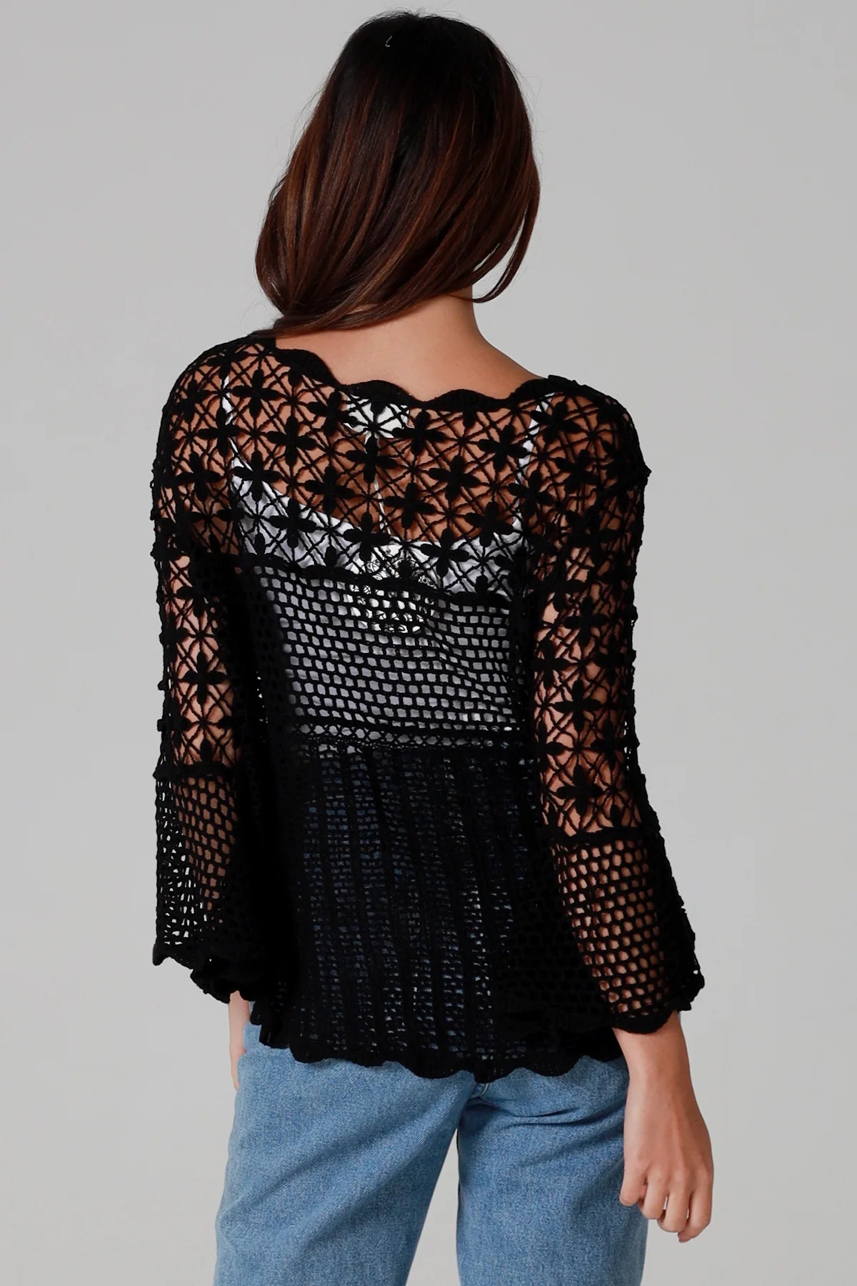 woman wearing black cotton crochet top with scalloped sleeves and flared hem - Boho crochet blouse Australia.