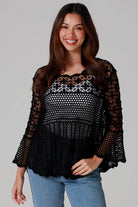 woman wearing black cotton crochet top with scalloped sleeves and flared hem - Boho crochet blouse Australia.